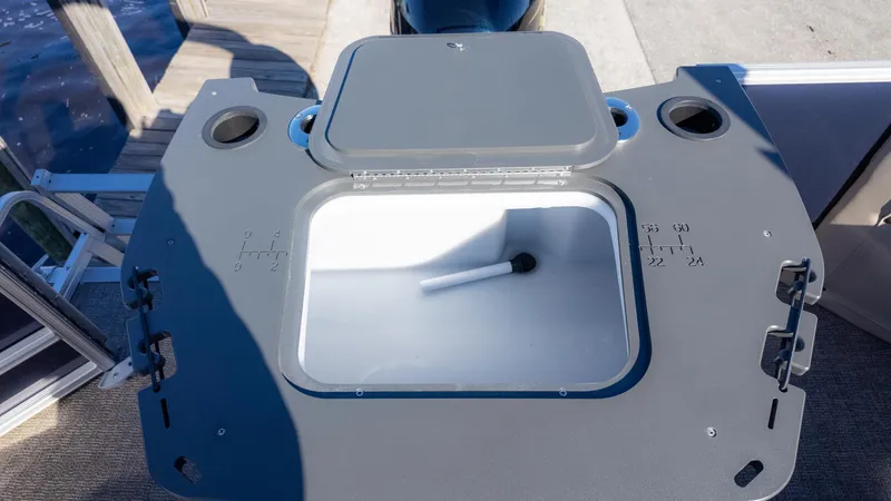 Slide: The Image of Bennington 21SF 2025 boat livewell with open lid, showing interior and measurements. - 18