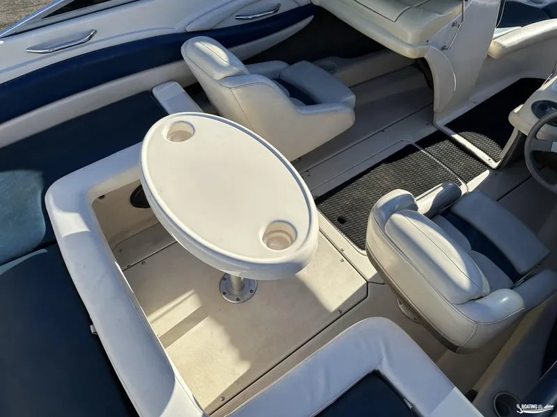 Slide: The Image of Interior of a 2002 Larson 210 SEI boat with seating and table. - 11
