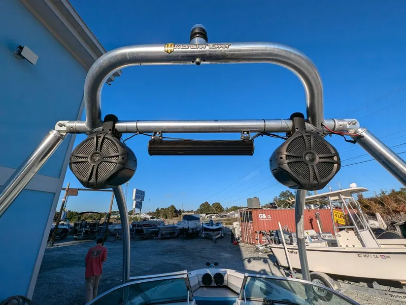 Slide: The Image of Chaparral 1900 SL 1992 boat with Monster Tower speakers, docked under clear blue sky. - 11