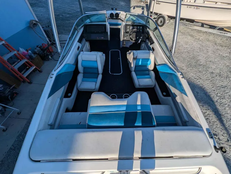 Slide: The Image of 1992 Chaparral 1900 SL boat interior with blue and white seating, steering wheel, and dashboard. - 4