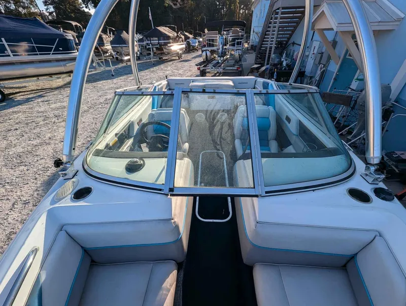 Slide: The Image of 1992 Chaparral 1900 SL boat with open windshield, parked in a marina. - 7