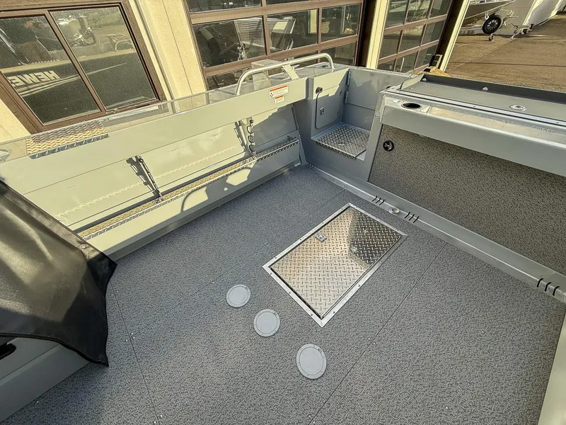Slide: The Image of 2025 Hewescraft 210 Sea Runner ET boat interior with storage compartments. - 14