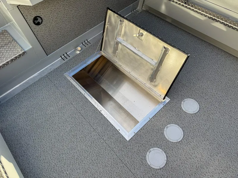Slide: The Image of 2025 Hewescraft 210 Sea Runner ET boat storage compartment, open hatch view. - 15