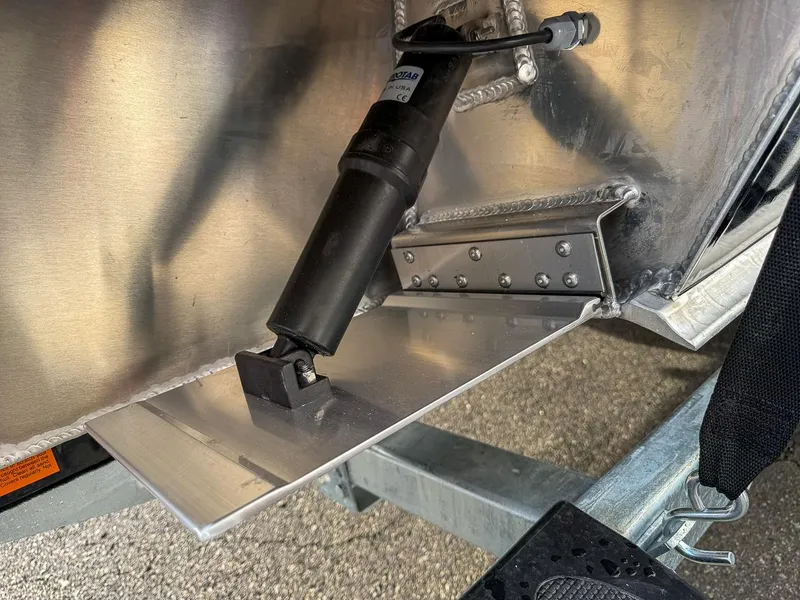 Slide: The Image of Close-up of 2025 Hewescraft 210 Sea Runner ET trim tab mechanism. - 19