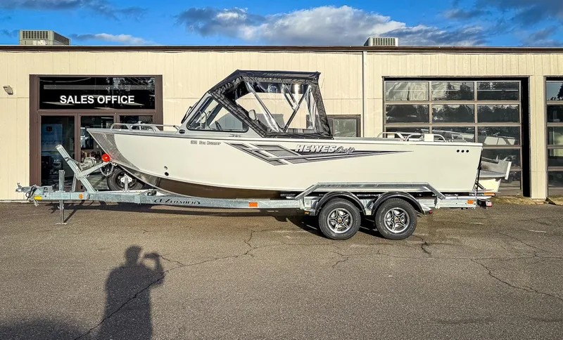 Slide: The Image of 2025 Hewescraft 210 Sea Runner ET boat on trailer outside sales office. - 2