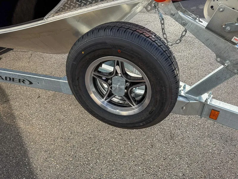 Slide: The Image of Trailer wheel of 2025 Hewescraft 210 Sea Runner ET on asphalt. - 20