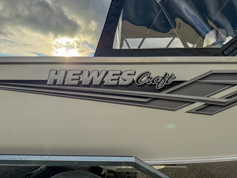 Slide: The Image of 2025 Hewescraft 210 Sea Runner ET boat side view with logo. - 21