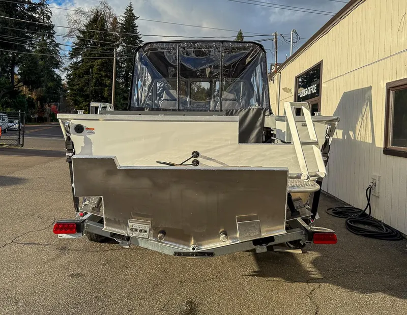 Slide: The Image of 2025 Hewescraft 210 Sea Runner ET boat, rear view, parked outside sales office. - 4