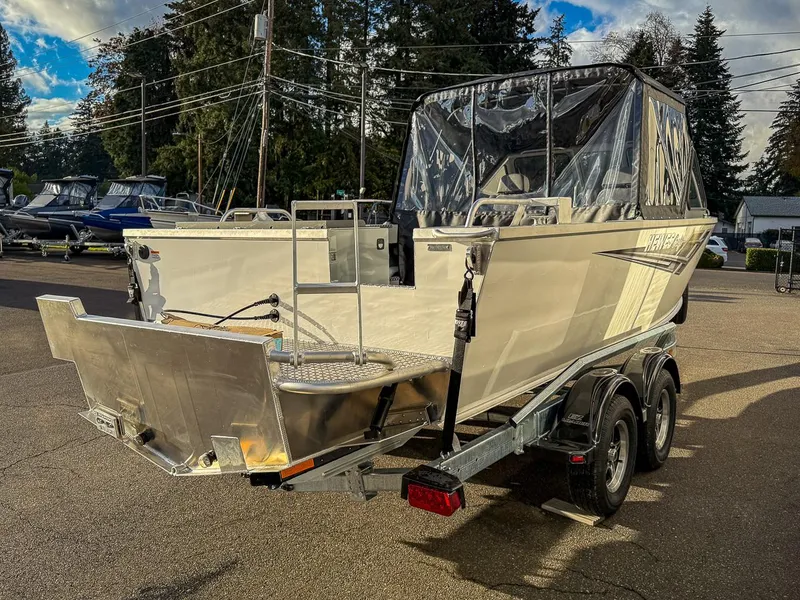 Slide: The Image of 2025 Hewescraft 210 Sea Runner ET boat on trailer, parked outdoors. - 5