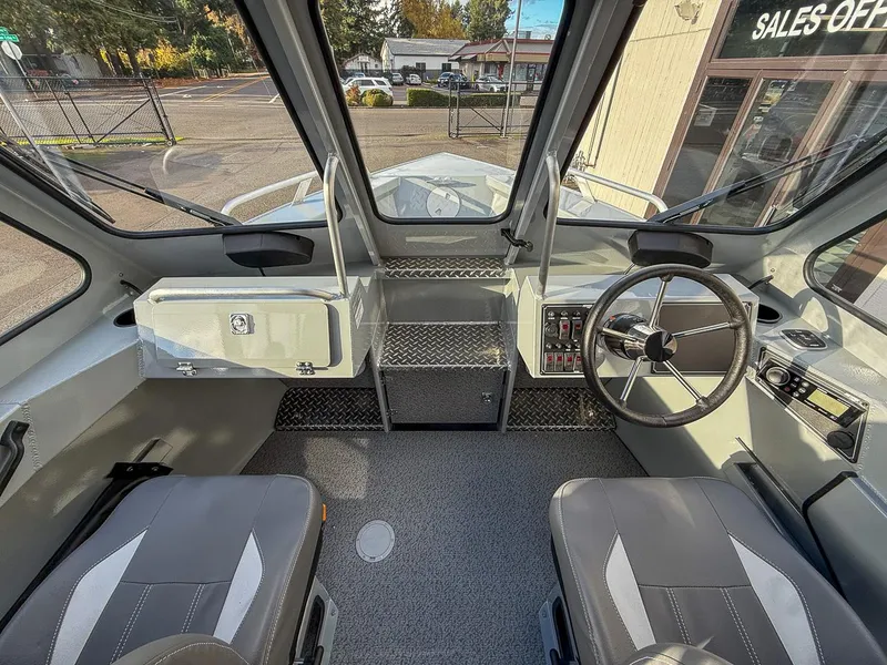 Slide: The Image of Interior of 2025 Hewescraft 210 Sea Runner ET boat, featuring modern controls and seating. - 8