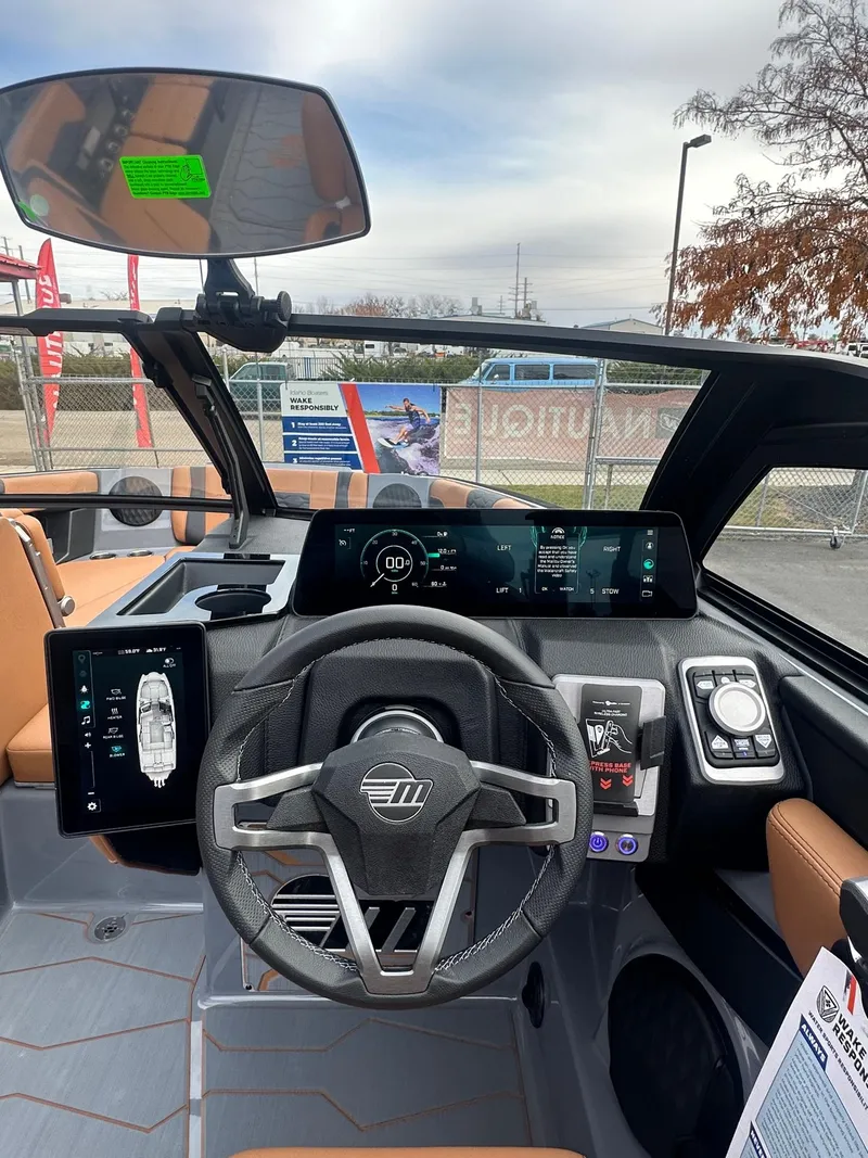 Slide: The Image of Interior view of 2025 Malibu 24 MXZ boat dashboard with modern controls and displays. - 19