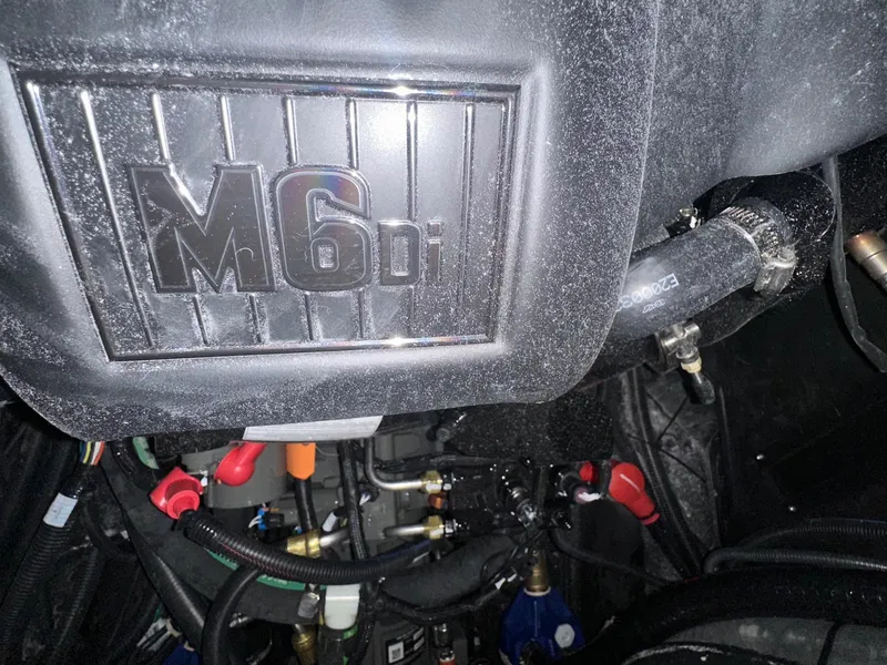 Slide: The Image of Engine compartment of 2025 Malibu 24 MXZ with M6di label, showcasing components and hoses. - 21