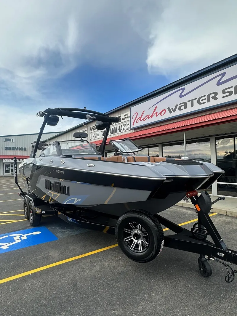 Slide: The Image of 2025 Malibu 24 MXZ boat on trailer at Idaho Water Sports dealership. - 4