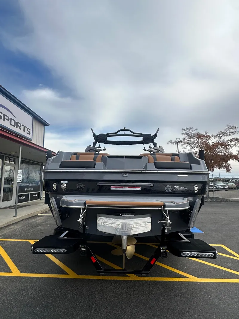 Slide: The Image of 2025 Malibu 24 MXZ boat displayed outside a sports dealership. - 9