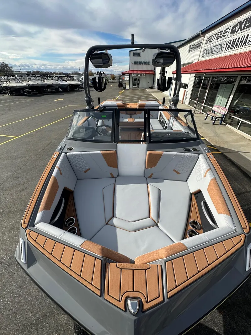Slide: The Image of 2025 Nautique GS22 boat with sleek interior design at a dealership. - 14