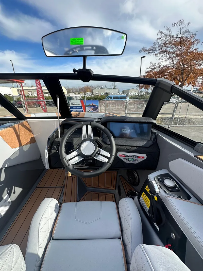 Slide: The Image of 2025 Nautique GS22 boat interior with modern dashboard and steering wheel. - 19