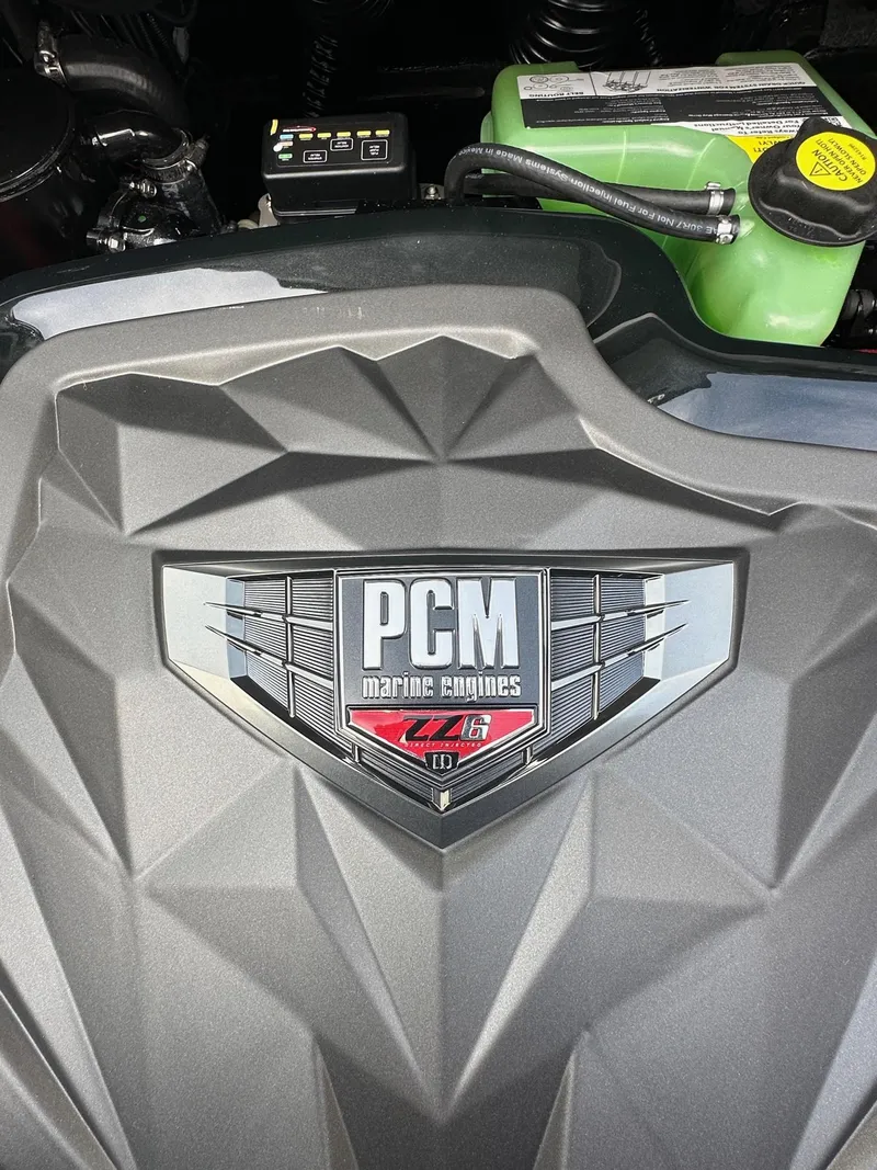 Slide: The Image of Engine cover of 2025 Nautique GS22 with PCM marine engines logo. - 21