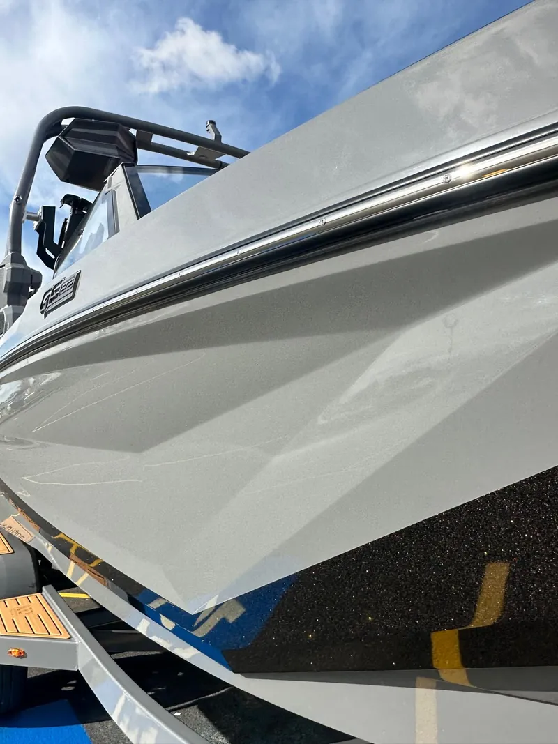 Slide: The Image of 2025 Nautique GS22 boat, sleek design, close-up view under blue sky. - 3