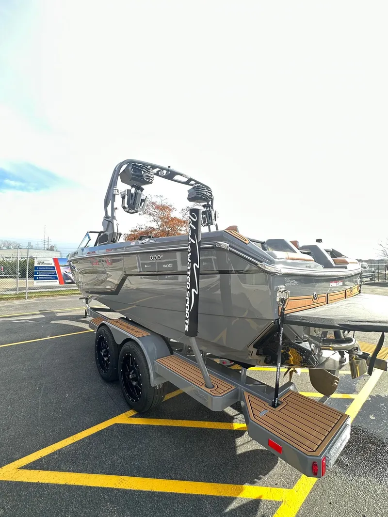 Slide: The Image of 2025 Nautique GS22 boat on trailer, sleek design, parked outdoors. - 8