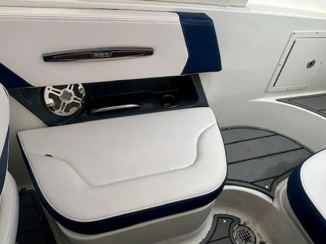 Slide: The Image of 2020 Chaparral 257 SSX boat interior with white and blue seating and speaker. - 15