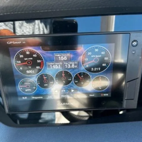 Slide: The Image of Garmin GPS display on 2020 Chaparral 257 SSX boat dashboard showing engine metrics. - 19