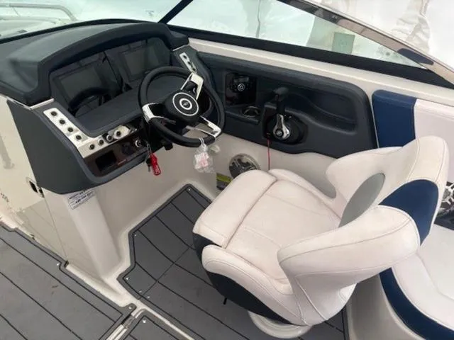 Slide: The Image of 2020 Chaparral 257 SSX boat cockpit with steering wheel and captain's chair. - 7
