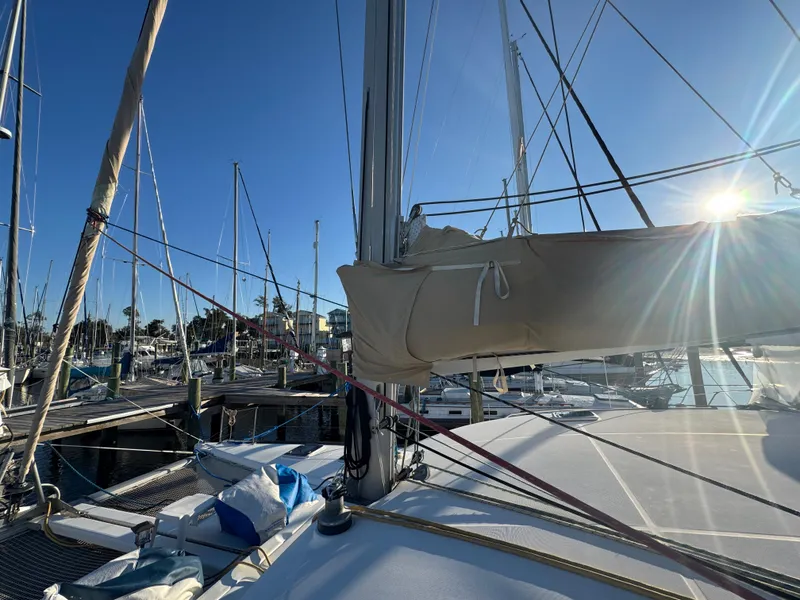 Slide: The Image of 2001 Lagoon 410 sailboat docked at marina under clear blue sky. - 10