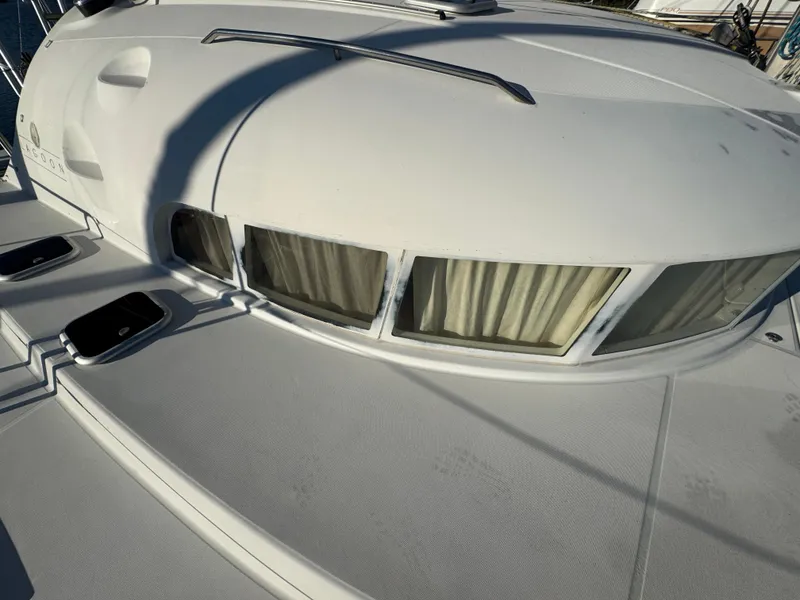 Slide: The Image of 2001 Lagoon 410 catamaran deck with windows and curtains. - 15