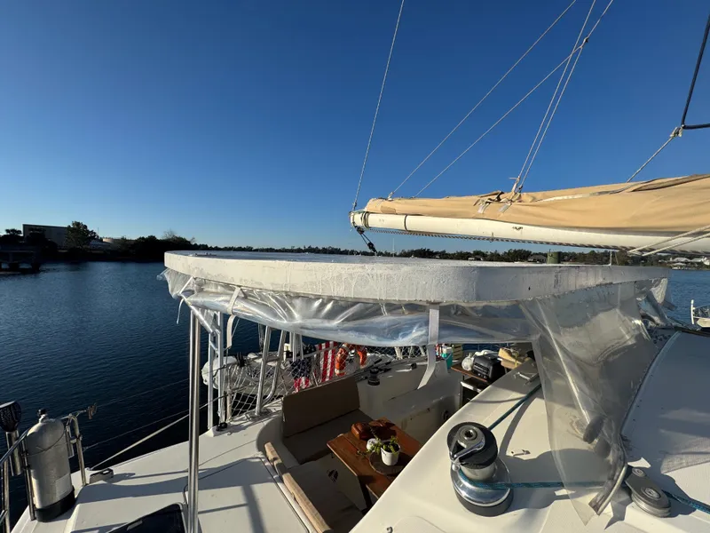 Slide: The Image of Lagoon 410 catamaran from 2001 on calm water under clear blue sky. - 17