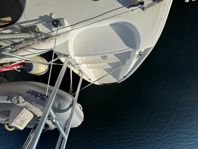 Slide: The Image of Aerial view of 2001 Lagoon 410 catamaran docked with dinghy on calm water. - 20