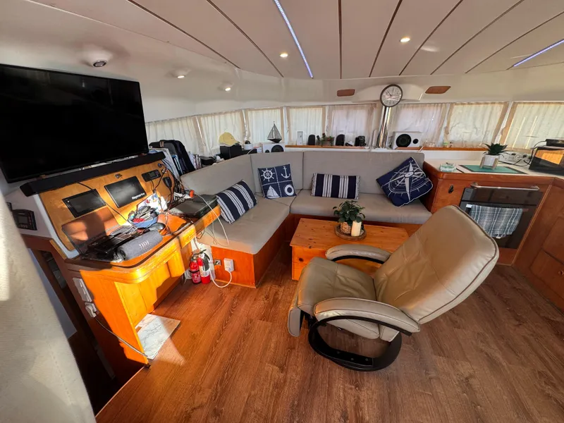 Slide: The Image of Interior of 2001 Lagoon 410 catamaran with cozy seating, navigation equipment, and modern decor. - 31