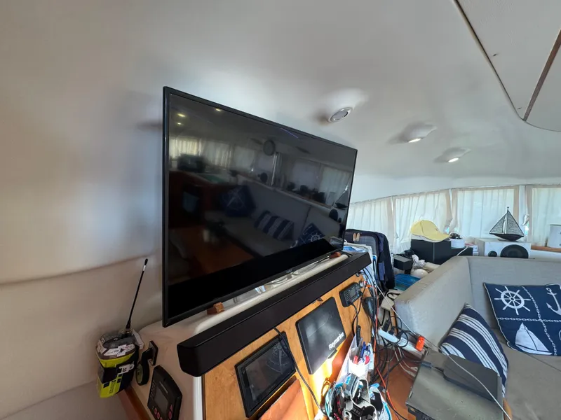 Slide: The Image of Interior of 2001 Lagoon 410 catamaran with TV and nautical decor. - 40