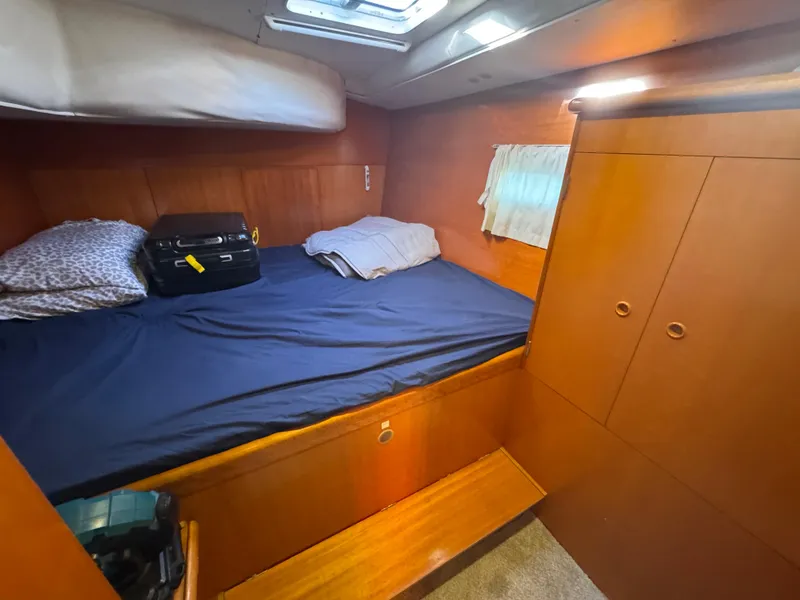 Slide: The Image of Cozy cabin interior of 2001 Lagoon 410 catamaran with bed and storage. - 43