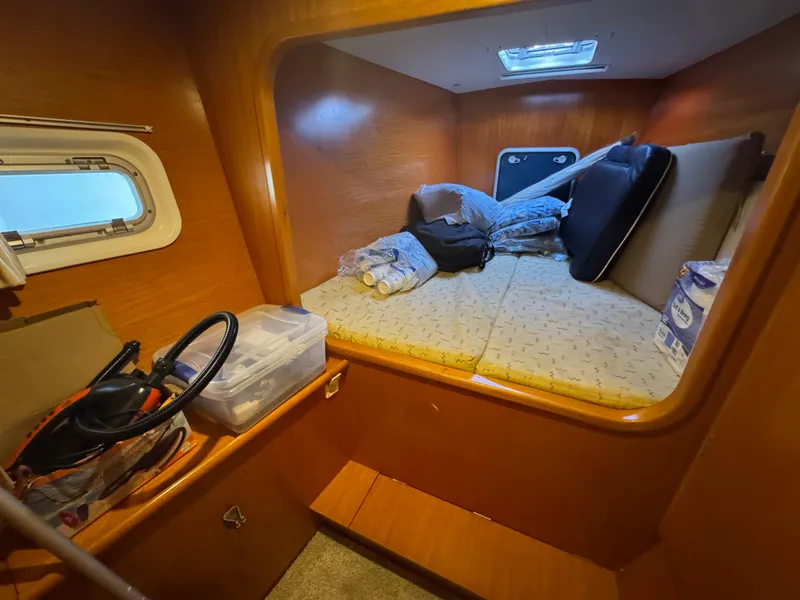 Slide: The Image of Cozy cabin interior of 2001 Lagoon 410 catamaran with storage and bedding. - 47