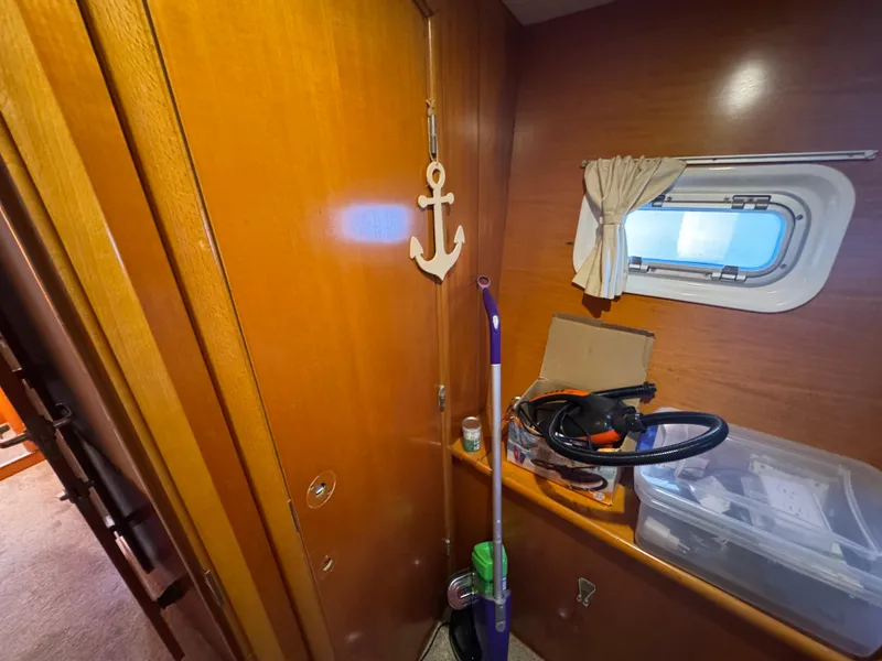 Slide: The Image of Interior of 2001 Lagoon 410 sailboat with wooden paneling and nautical decor. - 48