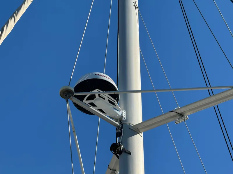 Slide: The Image of Sailboat mast with radar equipment on a 2001 Lagoon 410 under clear blue sky. - 5
