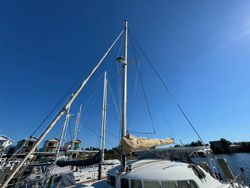 Slide: The Image of Lagoon 410 catamaran from 2001 docked under clear blue sky. - 6