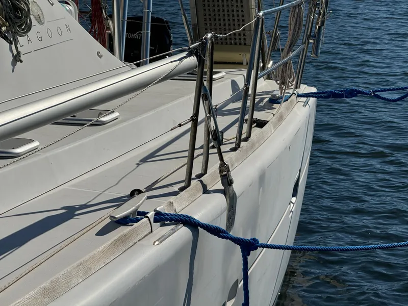 Slide: The Image of Lagoon 410 catamaran from 2001 docked with blue ropes on a sunny day. - 7