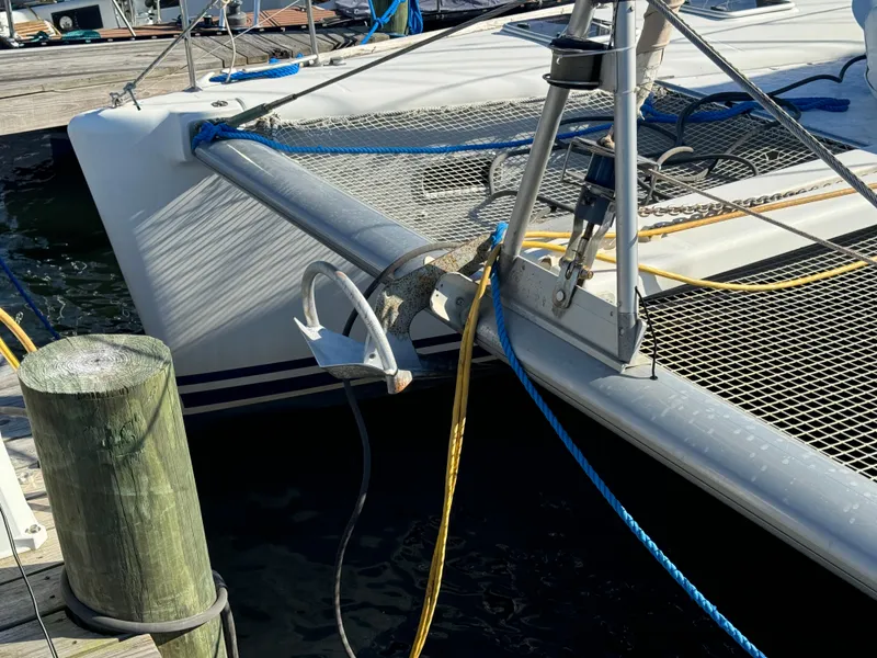 Slide: The Image of Lagoon 410 catamaran from 2001 docked, featuring anchor and netting. - 9
