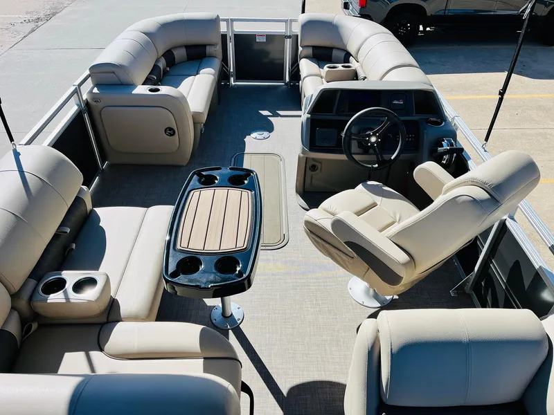 Slide: The Image of 2025 Sun Tracker Party Barge 22 RF XP3 interior with plush seating and steering console. - 10