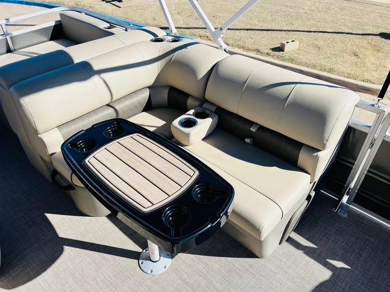 Slide: The Image of 2025 Sun Tracker Party Barge 22 RF XP3 interior with beige seating and table. - 24
