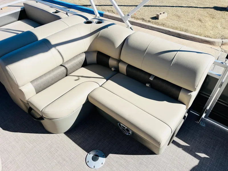 Slide: The Image of 2025 Sun Tracker Party Barge 22 RF XP3 with beige seating and cup holders. - 25