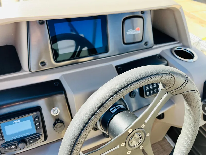 Slide: The Image of 2025 Sun Tracker Party Barge 22 RF XP3 dashboard with steering wheel and control panel. - 33