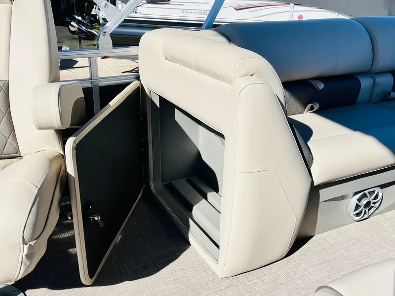 Slide: The Image of 2025 Sun Tracker Party Barge 22 RF XP3 interior storage compartment with beige seating. - 37