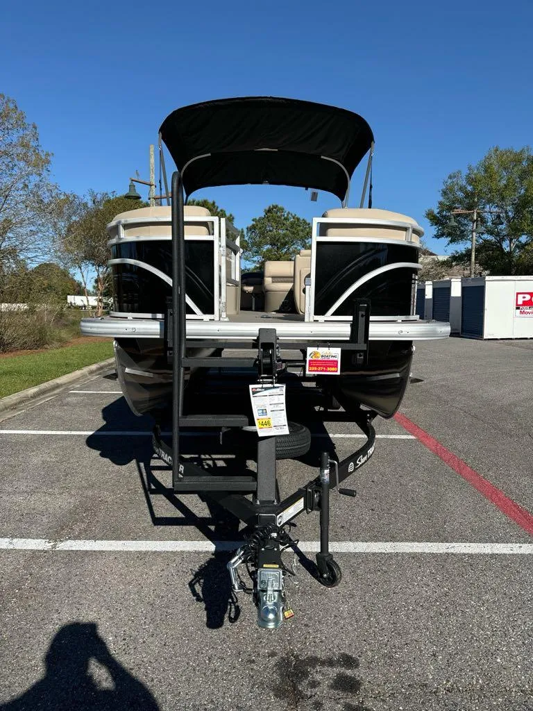 Slide: The Image of 2025 Sun Tracker SportFish 22 DLX pontoon boat on trailer in parking lot. - 3