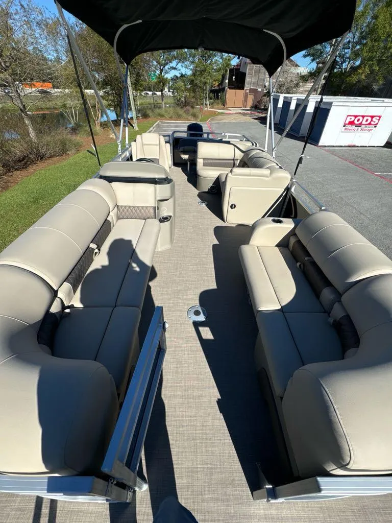 Slide: The Image of 2025 Sun Tracker SportFish 22 DLX pontoon boat with spacious seating and canopy. - 4