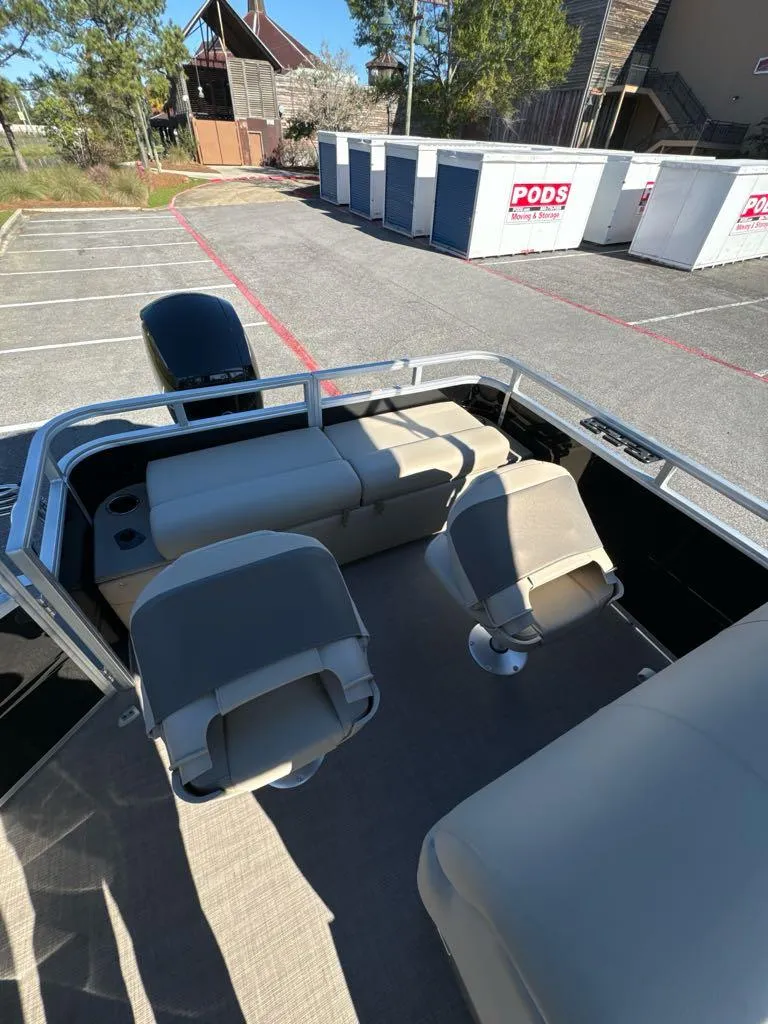 Slide: The Image of 2025 Sun Tracker SportFish 22 DLX pontoon boat interior with seating and storage. - 5