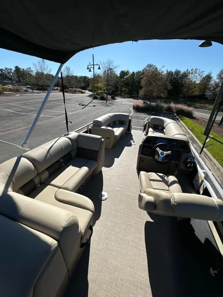 Slide: The Image of 2025 Sun Tracker SportFish 22 DLX pontoon boat with spacious seating and modern design. - 6