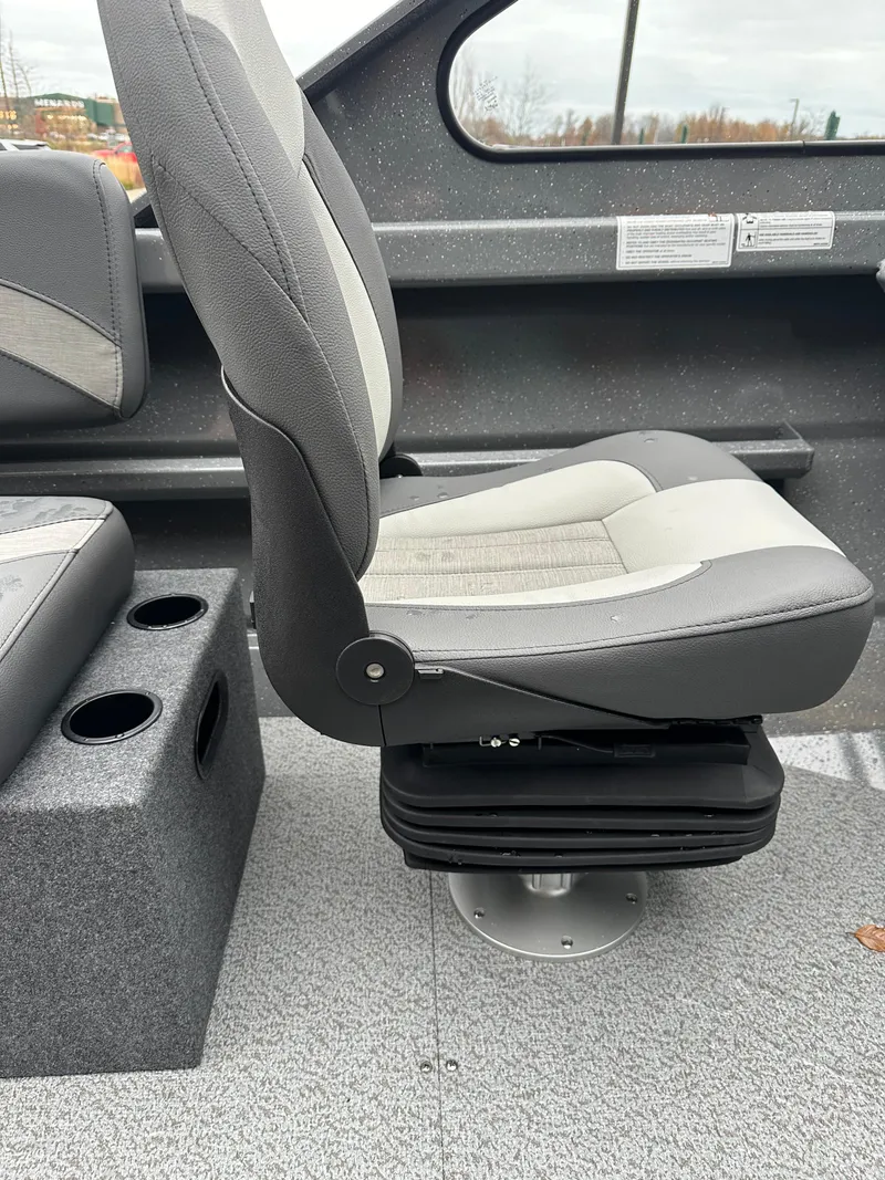Slide: The Image of 2025 Spartan 200 Astoria boat seat with gray upholstery and cup holders. - 13