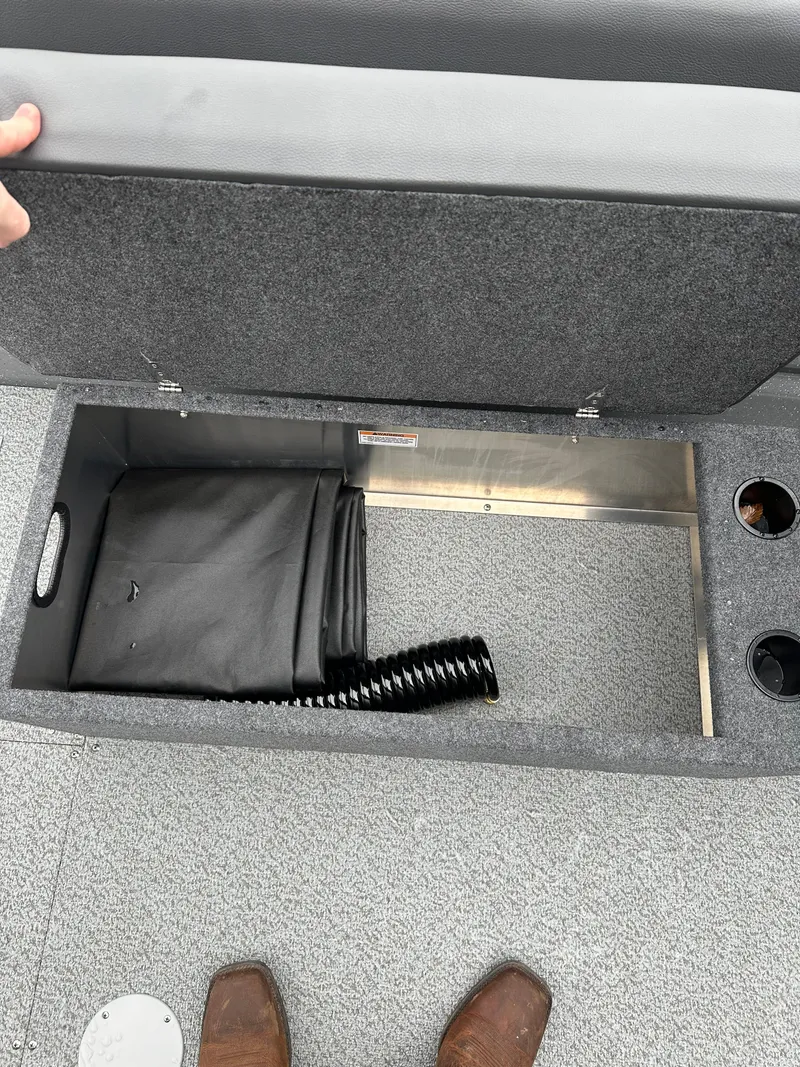 Slide: The Image of 2025 Spartan 200 Astoria storage compartment with hose and cover. - 17